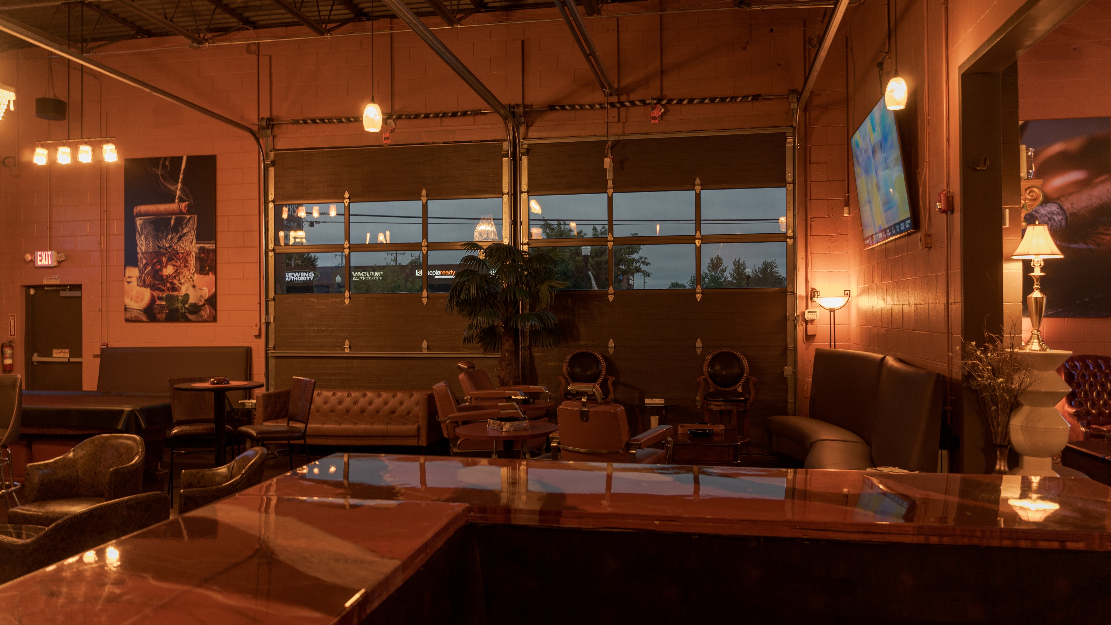 Warm light across the main lounge and glass bay doors at The Bay